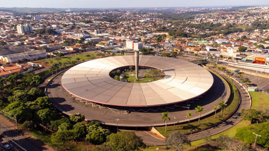 Vista aérea do terminal rodoviário de Londrina, com ônibus e a área urbana ao fundo